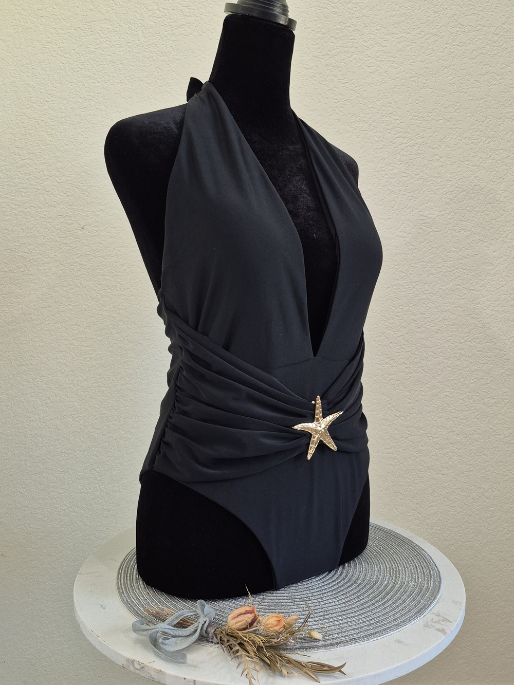Deep V-Neck Black One-Piece Swimsuit with Gold Star Accent